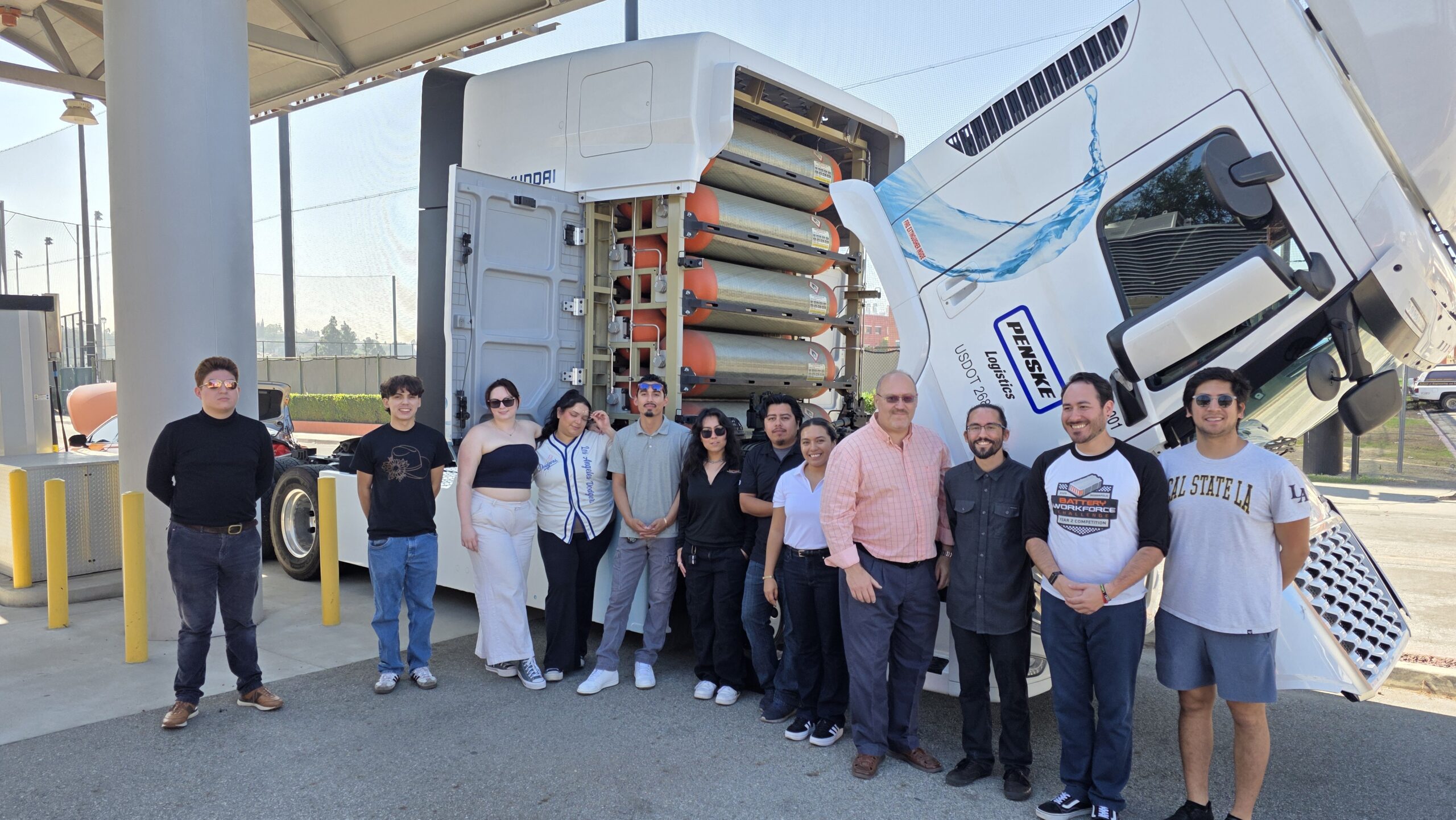 Dr. David Blekhman's research group at Cal State LA with a hydrogen-powered truck. Real equipment like this provides the foundation for students to develop systems literacy and practical hydrogen engineering skills.
